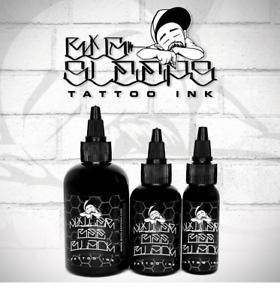 FYT Tattoo Supplies black tattoo ink bottles with logo, displayed against a brick wall background.